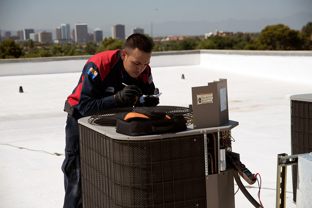 hvac technician checking air conditioner