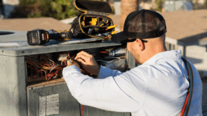 HVAC Technician working on an AC unit
