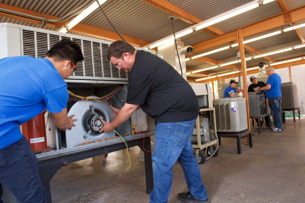 Two men working on HVAC installation