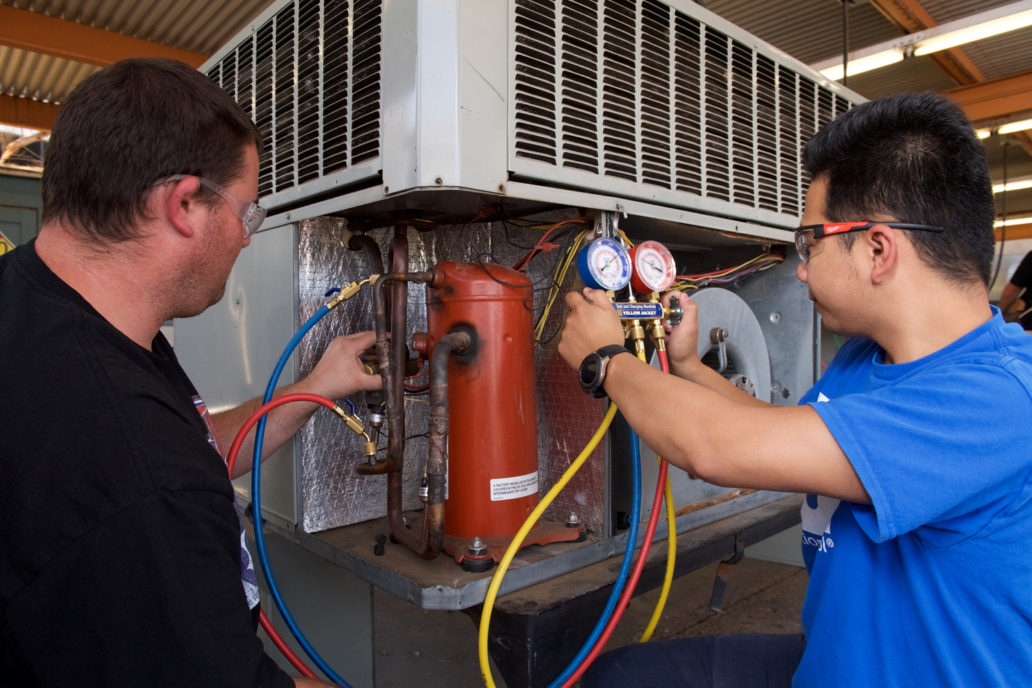 HVAC technicians updating wiring