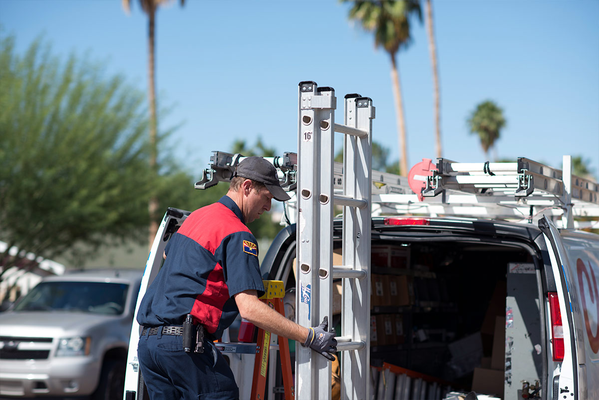 hvac technician behind work truck