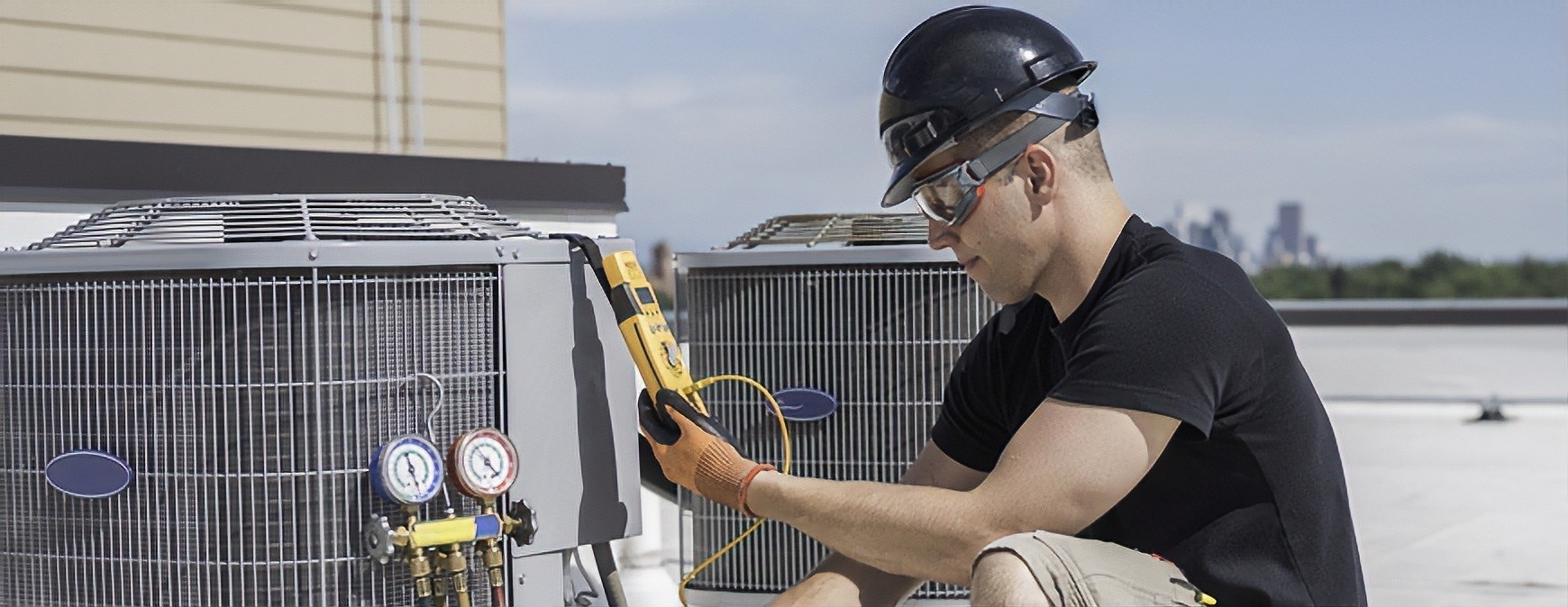 hvac technician checking rooftop ac