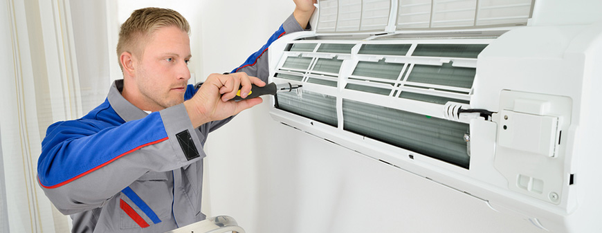 hvac technician fixing mini split system