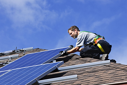 man installing solar panels