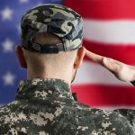 military veteran saluting us flag