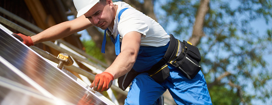 solar panel technician working in sun