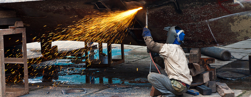 welder working on boat